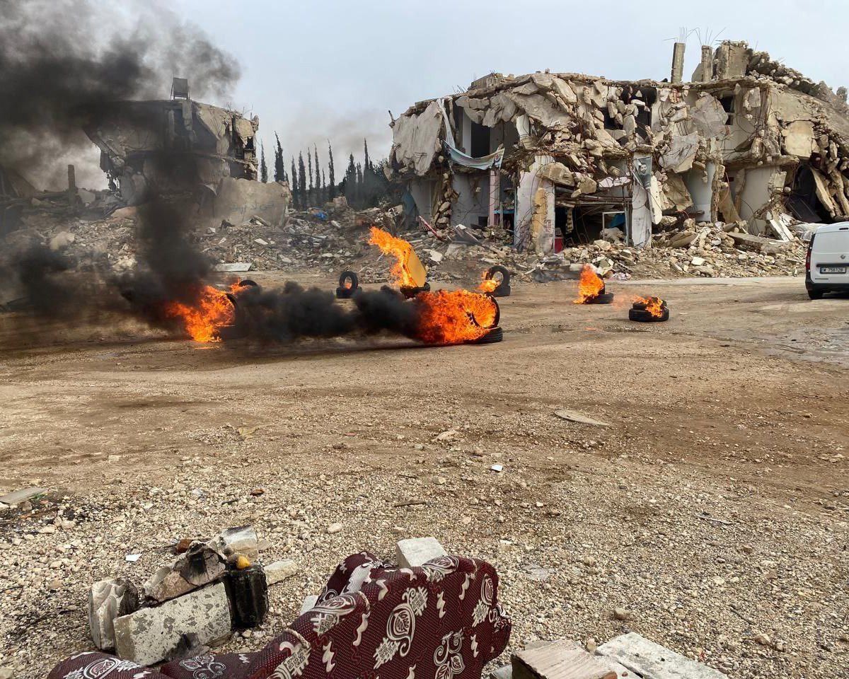 Residents of Kafrkila set tires alight to protest the plight of refugees and the reconstruction of the country